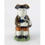 A Staffordshire Prattware pottery toby jug, circa 1840