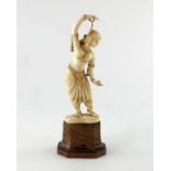 λ A 19th century Indian carved ivory figurine, modelled as a female dancer, on wooden base, 17cm hig