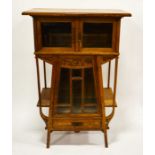 A French Art Nouveau cabinet, circa 1900, the tapered triangular form body, flanked by shelves, belo