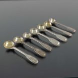 A matched set of seven George III and later silver salt spoons