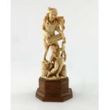 λ A 19th century Indian carved ivory figurine, modelled as a harmonium player with a female dancer,