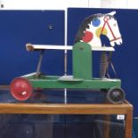 A painted wooden sit on Child's pull a long horse