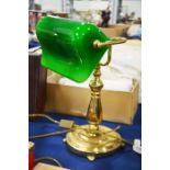 A brass and glass desk lamp.