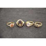 Four 9 carat gold rings, set with garnets etc.
