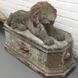 A pair of cast reconstituted stone lions with terr