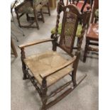 A 1920s oak barley twist and rush seated rocking c