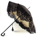 A 19th century black lace and silk parasol, jacket and skirt