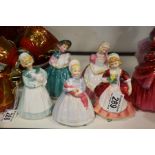 Five Royal Doulton figures including Rag Doll HN21