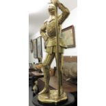 A brass standard lamp inthe form of a knight holdi
