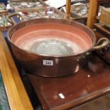 A large copper pan and an 18th century pewter plat