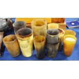 Sixteen various horn beakers, a Goat bell on woode