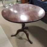 A George III mahogany tilt top tripod table, turne