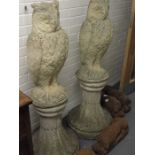A pair of cast stone garden ornaments in the form