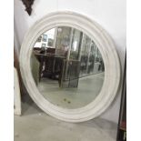 A large circular wooden framed wall mirror. 94cm