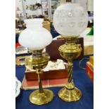 Two brass oil lamps with glass shades.