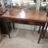 A George II mahogany fold over tea table, on ogee