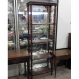 A reproduction four shelf bookcase, on turned supp