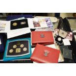 A collection of Royal Mint coin sets and silver pr
