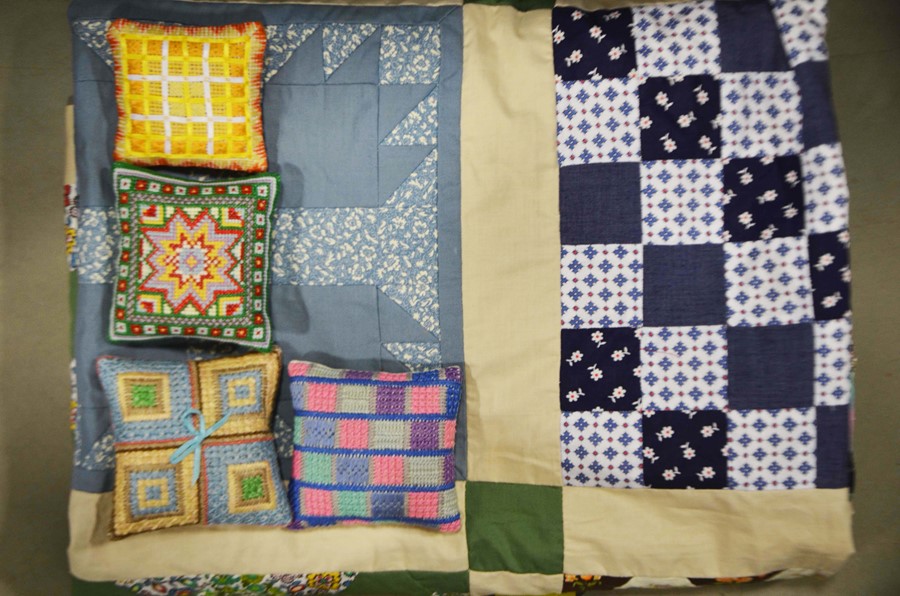 A patchwork quilt, lace bobbins and four sample st