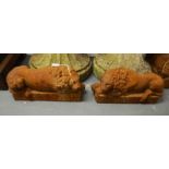 A pair of cast iron recumbent lions. (2)