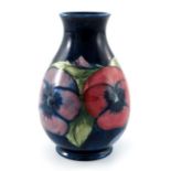 William Moorcroft, a small Pansy on blue vase, circa 1928, baluster form, impressed marks and