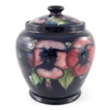 William Moorcroft, a Pansy on blue jar and cover, circa 1925, shouldered ovoid form, impressed marks