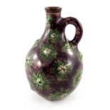 Edwin Martin for Martin Brothers, an earthenware gourd shaped flagon, 1895, relief moulded with