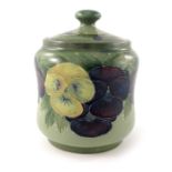 William Moorcroft, a Pansy on green jar and cover, circa 1916, waisted cylindrical ovoid form,