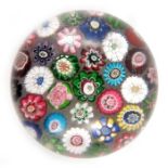Clichy, spaced millefiori paperweight, containing thirty-seven individual canes, including a Clichy