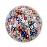 Baccarat, close-packed millefiori paperweight, including three Gridel silhouettes of a horse