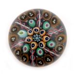 Paul Ysart, concentric millefiori paperweight with radiating orange and blue twists, unsigned, rough