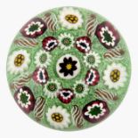 Paul Ysart, concentric millefiori paperweight with radiating white twists that have copper aventurin