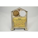 A silver calendar and twin picture frame