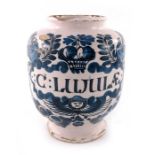 A London Delft drug jar, ovoid form, circa 1720, decorated in blue with a scrolling strapwork label