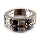 An 18 carat white gold, diamond and sapphire half eternity ring