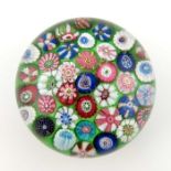 Clichy, spaced millefiori paperweight, containing thirty-seven individual canes, green ground, circa