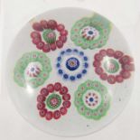 Clichy, patterned millefiori paperweight, seven garland rings each ring surrounding a central cane,