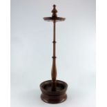 An early 20th century fruitwood church warden's pipe stand, with four apertures above a baluster tur