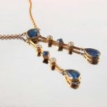 An Arts and Crafts South African diamond and sapphire double drop necklace on 15 carat gold