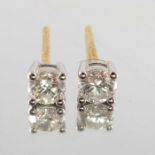 A pair of diamond stud earrings,