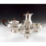 A E Jones, an Arts and Crafts silver four piece tea set, Birmingham 1924