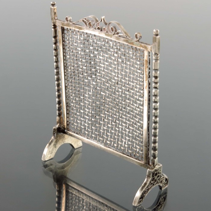 A novelty silver fire screen