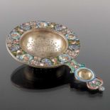 An Imperial Russian silver gilt and cloisonne enamelled tea strainer, 11th Artel, Moscow circa 1908