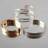 Two silver bangles and a 9 carat gold metal core bangle