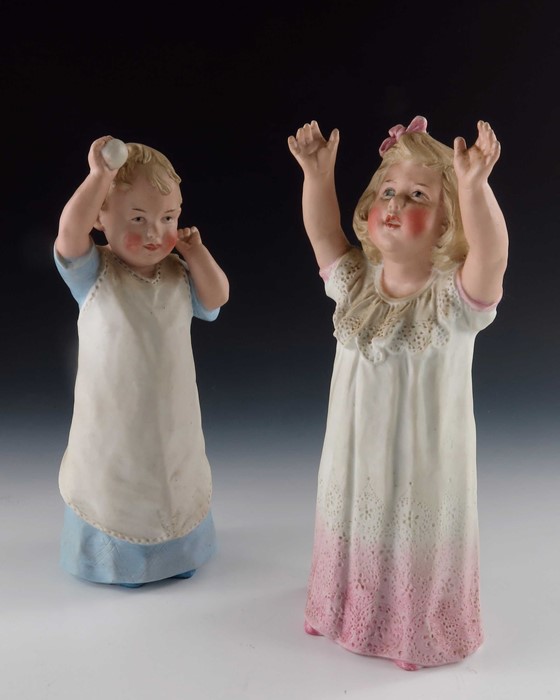 A pair of Gebruder Heubach bisque figures of young children playing