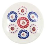 Clichy, patterned millefiori paperweight, seven garland rings each ring surrounding a central cane,