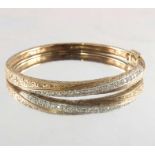 A 9ct gold diamond hinged bangle