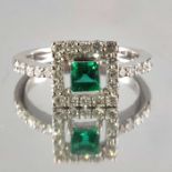 An 18ct gold emerald and diamond cluster ring