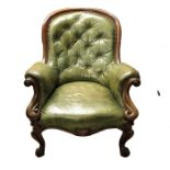 A Victorian carved mahogany and leather upholstered armchair
