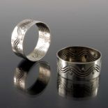 Bernard Cuzner for Liberty and Co., a pair of Arts and Crafts silver napkin rings, Birmingham 1912